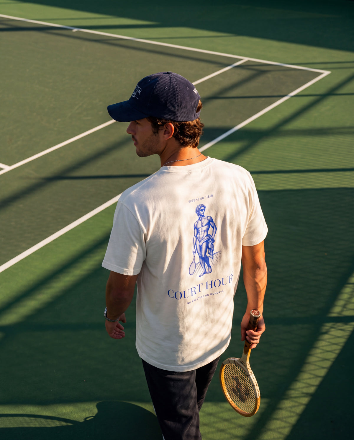 Navy Blue | Lifestyle | Weekend Heir Corduroy Cap in Navy Blue, side view on the court with a racket